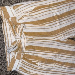 Small gold and white striped Rewind stretch pants with attached belt.